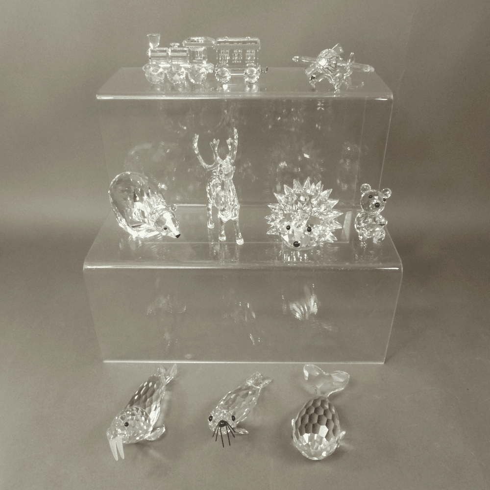 A mixed collection of Swarovski Crystal Animal figures and ornaments to include a Locomotive, Aeroplane, Polar Bear, Reindeer, Walrus, Hedgehog, Bear, Beaver etc 11 in total (1 tray) All in original boxes